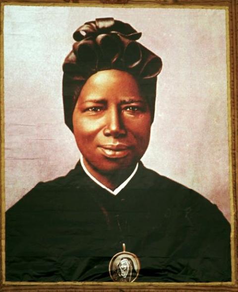 The feast day of St. Josephine Bakhita, an enslaved African who died in 1947, is Feb. 8. A tapestry that depicts her hangs from the facade of St. Peter’s Basilica during her canonization in 2000 at the Vatican in this file photo. (CNS/Reuters/L'Osservator