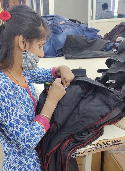 The daughter of a leprosy patient works in a garment factory within the Sumanahalli campus in Bengaluru, southern India. (Thomas Scaria)