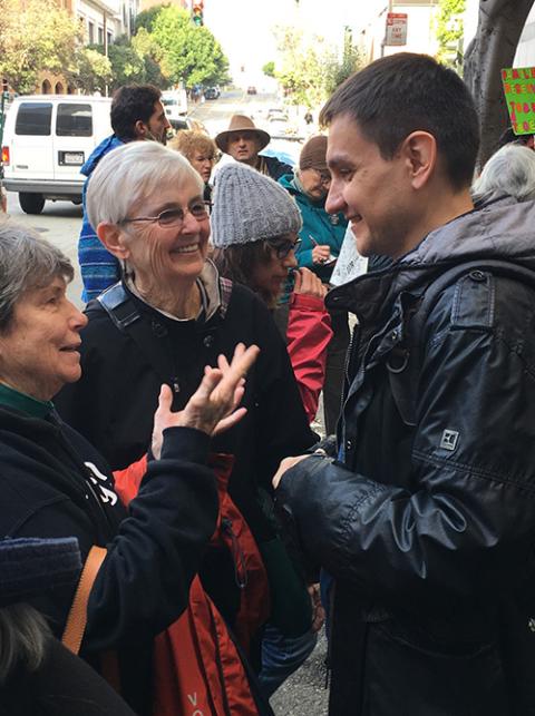 Following a 2018 vigil in front of U.S. Immigration and Customs Enforcement headquarters in San Francisco, Mercy Sr. Judy Carle, left, and Mercy Sr. Joan Marie O'Donnell rejoice with Alexi, a migrant who had been freed from over a year in detention. The s