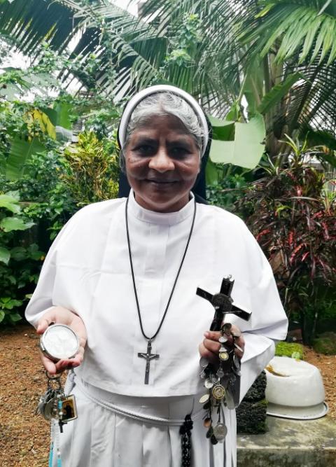 Franciscan Clarist Sr. Lissy Vadakkel, a key witness in the rape case against Bishop Franco Mulakkal, displays lockets of saints, a rosary, religious relics and a crucifix engraved with "Missionaries of Jesus," the congregation of the rape survivor. Franciscan Clarist Sr. Lissy Vadakkel, a key witness in the rape case against Bishop Franco Mulakkal, displays lockets of saints, a rosary, religious relics and a crucifix engraved with "Missionaries of Jesus," the congregation of the rape survivor.