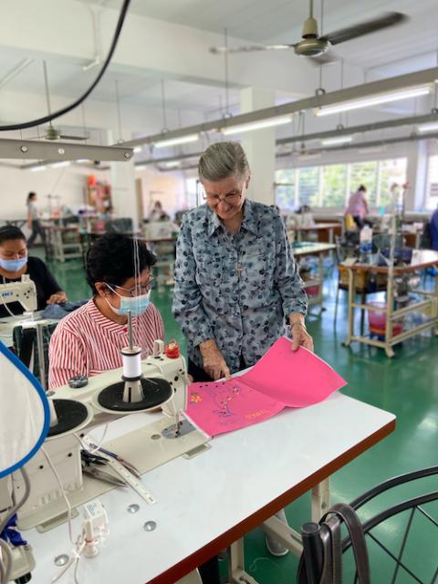 Good Shepherd Sr. Louise Horgan talks to a woman sewing at the Fatima Self Help Centre in Bangkok, Thailand. (Provided photo)