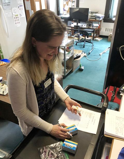 Maggie Schauff prepares medicine for pop-up clinics as part of her work at her St. Joseph Worker Program placement site, St. Mary's Health Clinics in St. Paul, Minnesota, in May. (Courtesy of the St. Joseph Worker Program)