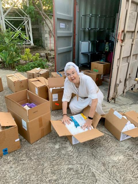 Felician Sr. Marilyn Marie Minter packs boxes of clothing and medical supplies in Jacmel, Haiti, to send to Les Cayes on Aug. 14, following the earthquake in southern Haiti.