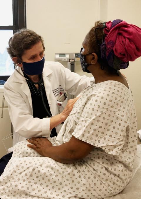 Dominican Sr. Mary Flood, left, attends to a patient at her practice in New York City earlier this year. (Courtesy of the Sisters of St. Dominic of Blauvelt)