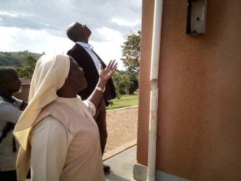 Sr. Mary Grace Akiror looks at a broken pipe during an inspection of a government project in western Uganda. (Gerald Matembu)