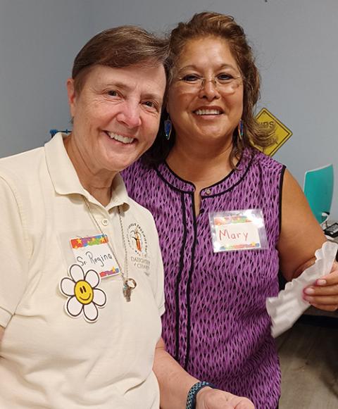 Sr. Regina Hlavac of the Daughters of Charity, left, and Mary Santos, a second-grade teacher from Robb Elementary who led arts and crafts at Camp I-CAN, in July in Uvalde, Texas (Courtesy of Dolores Aviles)