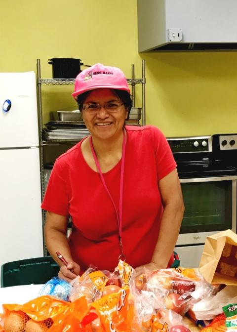 Dubuque Franciscan Sr. Reyna Helen Badillo sorts through food to be delivered in Mississippi. (Courtesy of Sr. Nancy Schreck) Dubuque Franciscan Sr. Reyna Helen Badillo sorts through food to be delivered in Mississippi. (Courtesy of Sr. Nancy Schreck)