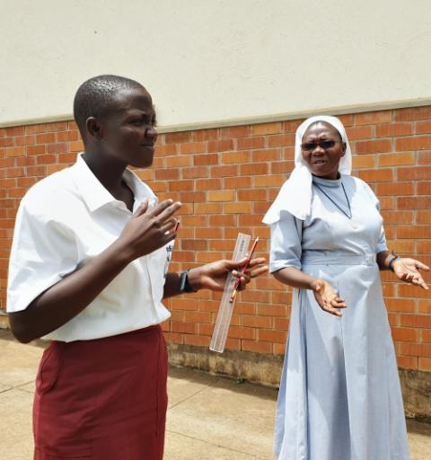 Sr. Rose Nelima converses with one of her deaf students at Mbale School for the Deaf in Uganda. (Gerald Matembu)