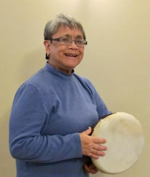 Sr. Terri Laureta playing a hand drum (Courtesy of Terri Laureta)