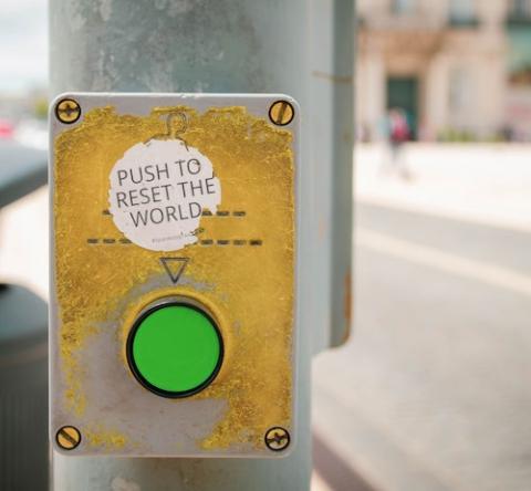 Sticker on lightpost by a button that says "Push to reset the world" (Unsplash/Jose Antonio Gallego Vazquez) Sticker on lightpost by a button that says "Push to reset the world" (Unsplash/Jose Antonio Gallego Vazquez)