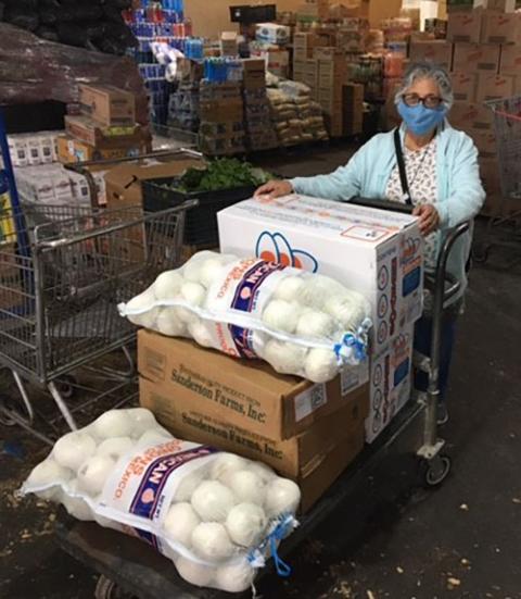 Benedictine Sr. Ursula Herrera buys food to distribute in Piedras Negras, Mexico. She makes regular food and supply runs to a home for special-needs adults and an orphanage on the Mexico side of the U.S.-Mexico border. (Courtesy of John Bivens) Benedictine Sr. Ursula Herrera buys food to distribute in Piedras Negras, Mexico. She makes regular food and supply runs to a home for special-needs adults and an orphanage on the Mexico side of the U.S.-Mexico border. (Courtesy of John Bivens)