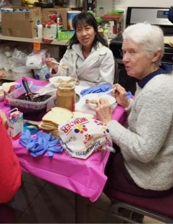 Sisters take a break from making sandwiches.