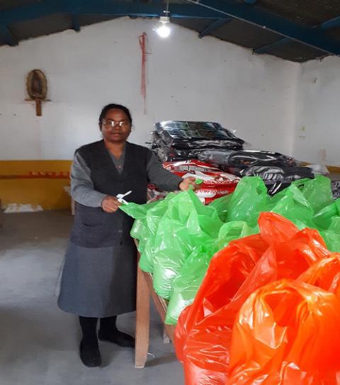 Sister Hilda helps in the parish, packing groceries for people affected by COVID-19. (Courtesy of Hilda Mary Bernath)