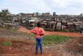 A young woman stands on a hillside looking over a poor section of Nairobi, Kenya, April 19, 2020, during the COVID-19 pandemic. (CNS/Reuters/Thomas Mukoya)