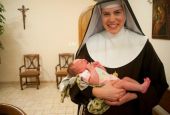 Mother Mary Paschal of the Lamb of God holds her infant niece, Cecelia Potee, in 2011.