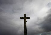 A cross is silhouetted outside a Catholic church Oct. 5 near Nantes, France. (CNS/Reuters/Stephane Mahe)