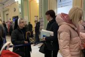 Sr. Lucja Kwasniak, a member of the Sisters, Servants of the Immaculate Heart of Mary, talks to Ukrainian refugees April 21 at the train station in Przemysl, Poland.