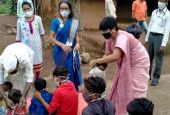Medical Mission Sr. Seema Bhalrai, coordinator of Child Help Line, ties a mask on a child (Courtesy of Celine Paramundayil)
