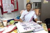 Sr. Judith Meckado of the Franciscan Missionaries of Christ the King displays a photo album with pictures of "A Pilgrimage of the Heart" at her office in Old Goa, western India. (Lissy Maruthanakuzhy)