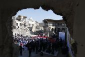 People gathered in bombed out church square with Pope Francis in Mosul, Iraq