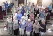 Sisters in the Adrian Dominican auditorium in Adrian, Michigan, give Dominican Sr. Elise García a standing ovation at the conclusion of her Aug. 11 presidential address to the Leadership Conference of Women Religious. (GSR screenshot)