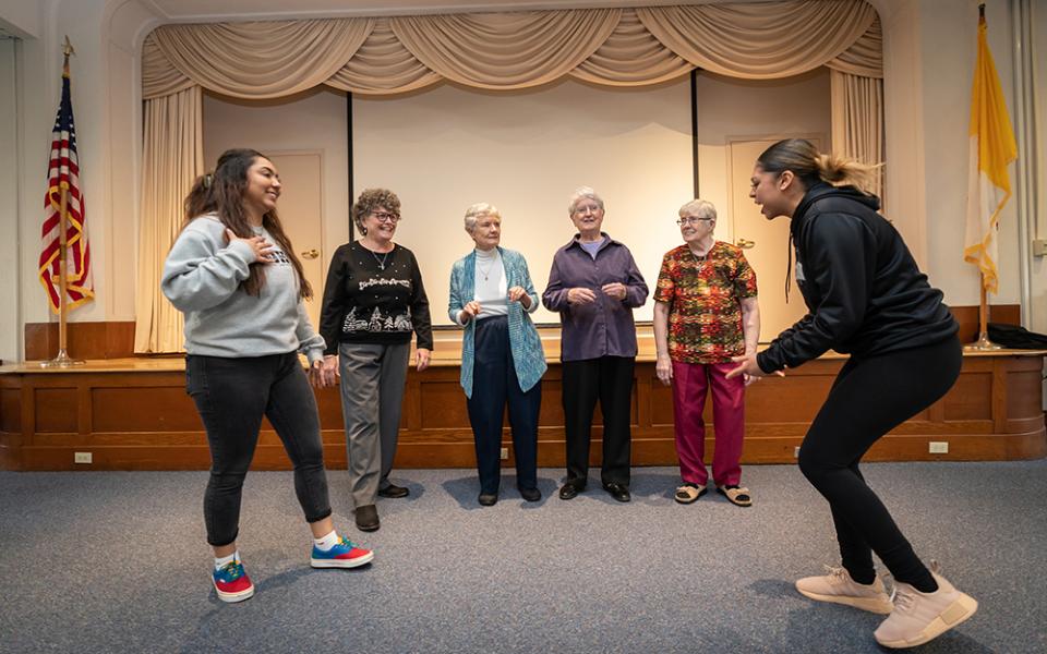 Neumann University students and four Sisters of St. Francis of Philadelphia practice a TikTok video