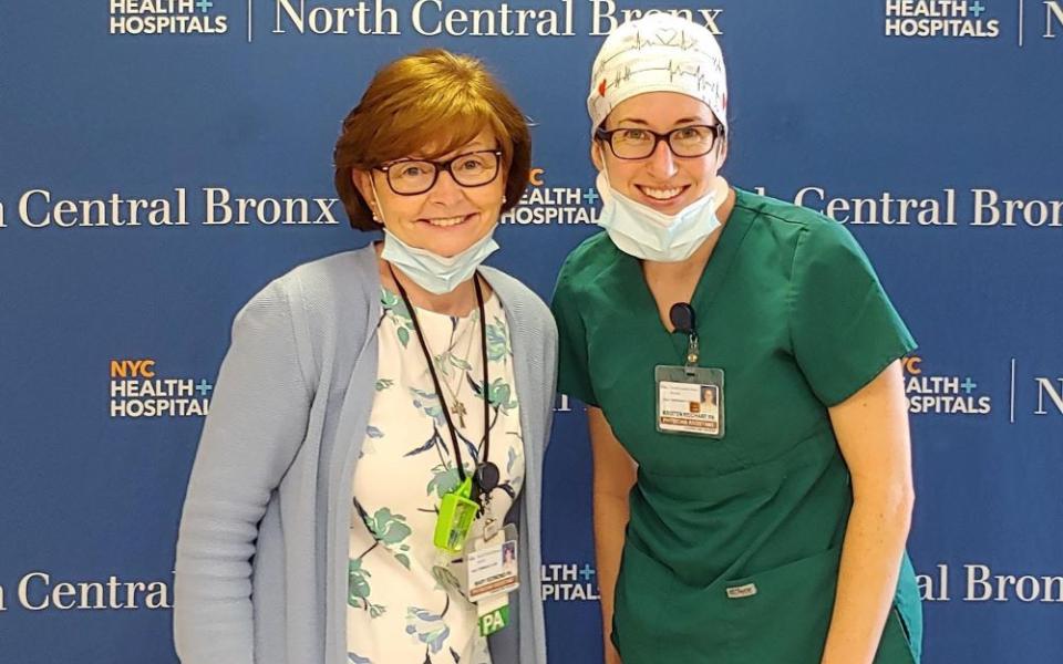 Sr. Mary Catherine Redmond, left, stands with physician assistant Kristen Reichart after an operations meeting for planning at the hospital where she worked during the early days of the COVID-19 pandemic. 