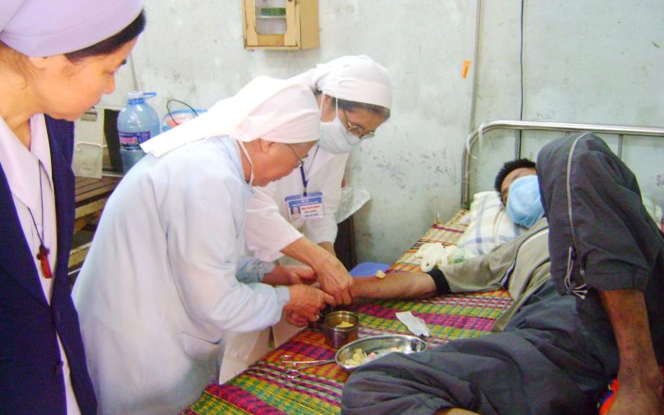 Sr. Josephine Huynh Thi Ly (center) and another nun inject a patient at the Central Hospital in Hue in April 2023. 