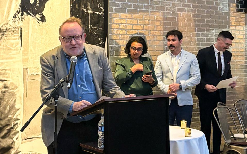 Chris Herlinger, international correspondent for Global Sisters Report, accepts an award from the Religion News Association on behalf of GSR staff for the series "Hope Amid Turmoil" at an April 20 ceremony at the Warhol Museum in Pittsburgh. (GSR photo/Olivia Bardo)