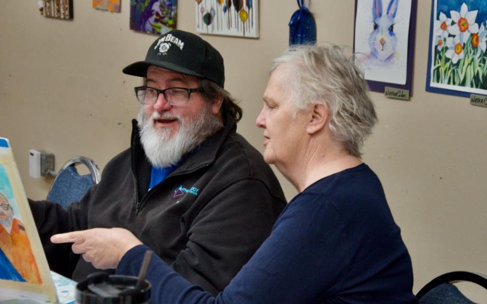 Daughters of Charity Sr. Brenda Fritz, right, consults with painting student Zack Davisson at Presentation Arts Center in St. Louis March 11. 