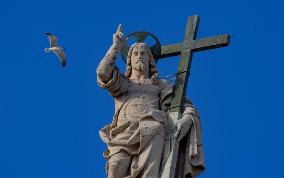 The statue of the Risen Christ on top of the facade of St. Peter's Basilica at the Vatican 