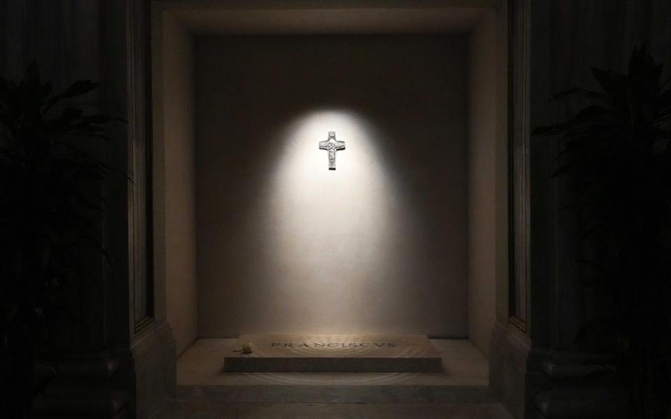 A light shines on a replica of Pope Francis' pectoral cross above his tomb in the side aisle of Rome's Basilica of St. Mary Major early April 27, 2025. (CNS/Lola Gomez)