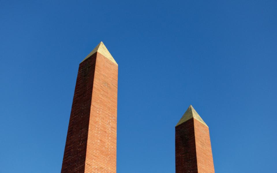 2 pillars against a very blue sky