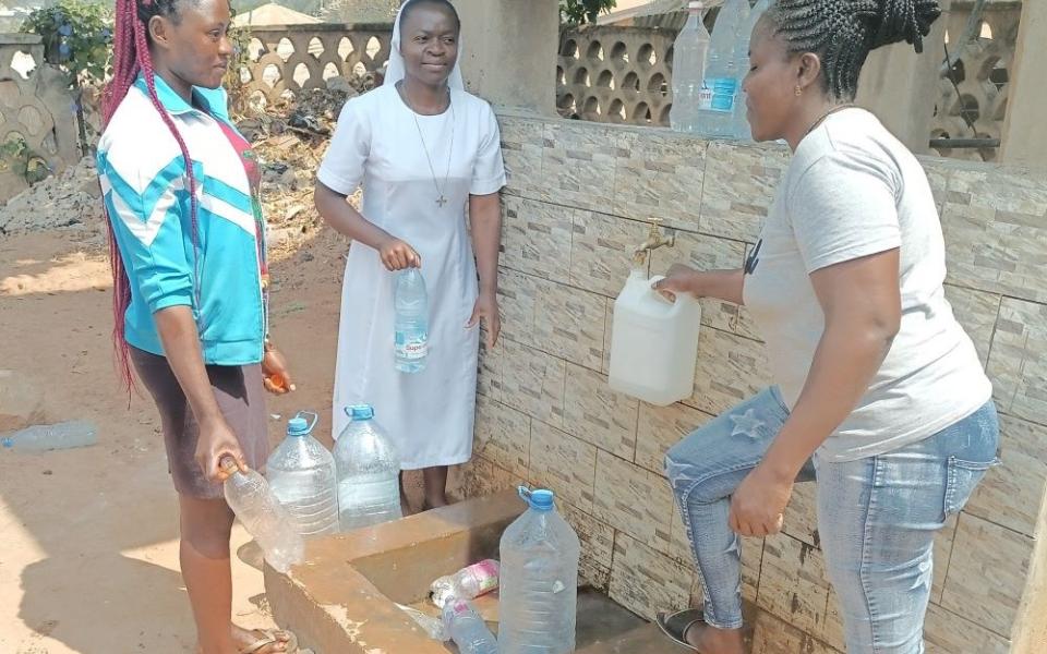 Sr. Kum Shallotte (center), motivated by the need for clean water in the Northwest Region of Cameroon, advocated for and secured a solar-powered borehole for her community. (Courtesy of Kum Shallotte)