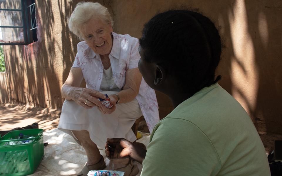 Sr. Mary Courtney visits a patient. Courtney is a member of the Franciscan Missionary Sisters for Africa. (Derrick Silimina)