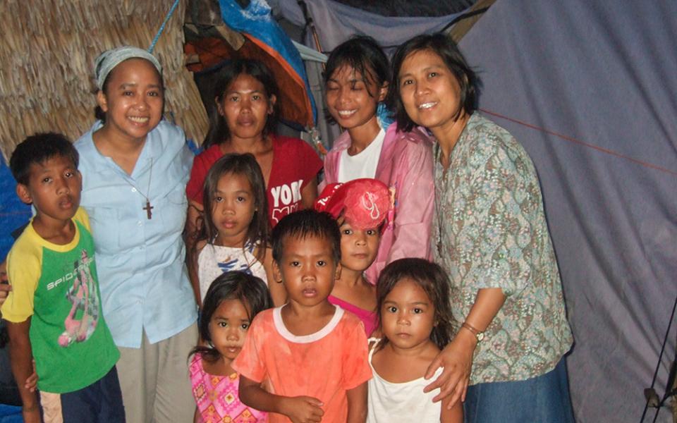 Verbum Dei Missionary Sr. Luisa Mesina, second from left, with the people of Guiuan, Eastern Samar, in the Philippines, after the devastation of the super typhoon of November 2013. (Courtesy of Luisa Mesina)