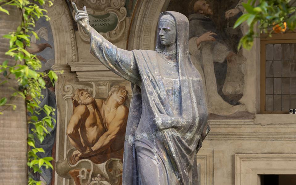A statue of St. Catherine of Siena is seen in the cloister of the Dominican friars' convent next to the Basilica of Santa Maria Sopra Minerva in Rome April 18, 2024. On Aug. 3, 2025, Sr. Annie Killian professed perpetual vows as a Dominican Sister of Peace. The sisters shared with her the charism from Sts. Dominic and Catherine. (CNS/Pablo Esparza)