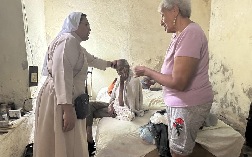 Carmelite Missionary of St. Joseph Sr. Noemy Ayala visits a family Nov. 12, 2025, in Havana. Though the sisters' mission focuses on children, the community also visits the elderly and used to be able to take meals to them, something that has become more difficult to do now because of food shortages and high inflation on the island. (GSR photo/Rhina Guidos)