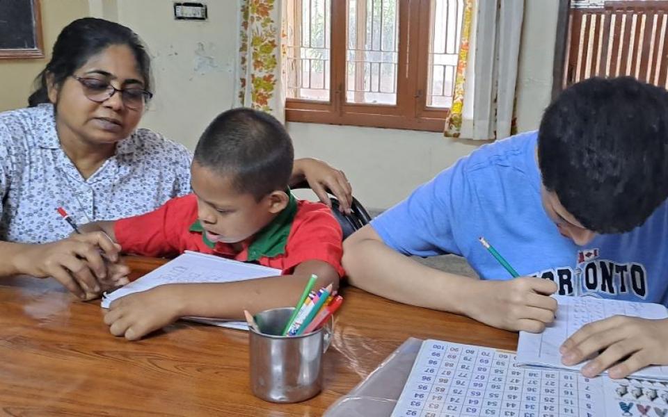 Marist Missionary Sr. Suporna Rozario teaches two children with disabilities at a center in Bangladesh. Rozario administers two centers in Dhaka, which serve 51 people (mostly children) with disabilities. (Courtesy of Suporna Rozario)