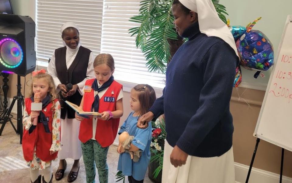 Srs. Imelda Ngwitu and Ancilla Abonyo interact with members of Holy Family Catholic Church's American Heritage Girls troop, a Christian-based organization with a focus on leadership for girls. Through the group, Ngwitu and Abonyo, both from Nairobi, Kenya, got to know the small community of Blakely, Georgia, where they served as members of the Ohio-based Glenmary Home Missioners. Abonyo has since left the area, but Ngwitu still serves there. (Courtesy of Dorann Cobb)