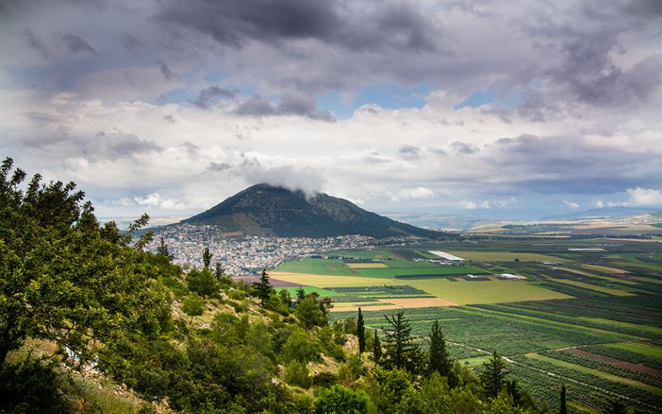 Clouds pass over Mount Tabor in the distance in Galilee, Israel. The mount is traditionally known as the site of Jesus' transfiguration. (Wikimedia Commons/Reutmaor)