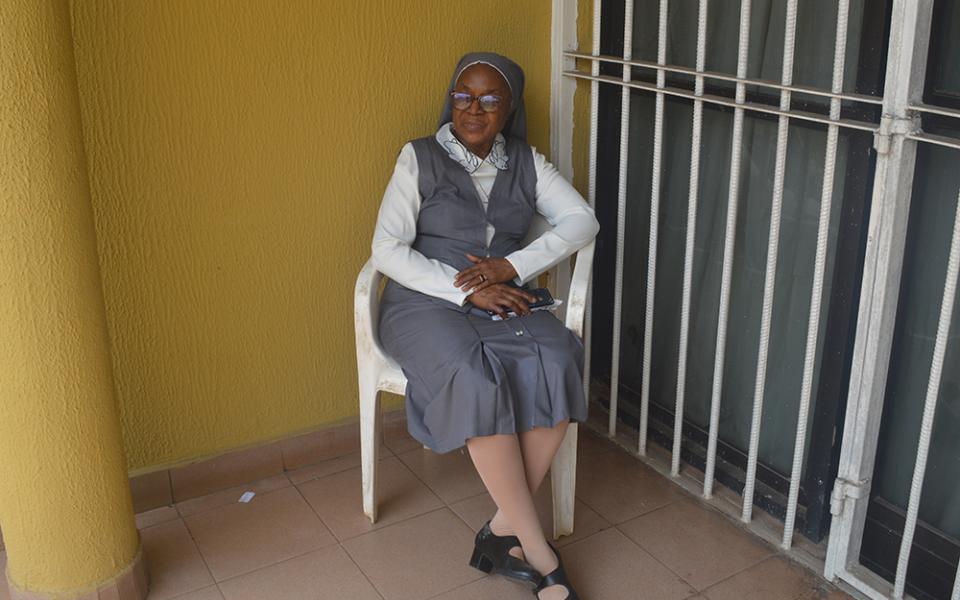 Sr. Anthonia Ibeh, a member of the Medical Missionaries of Mary Ibeh who leads the catechism class every Wednesday for two hours to inmates, poses in front of the sisters' convent in Benin City, Nigeria. (Valentine Benjamin)