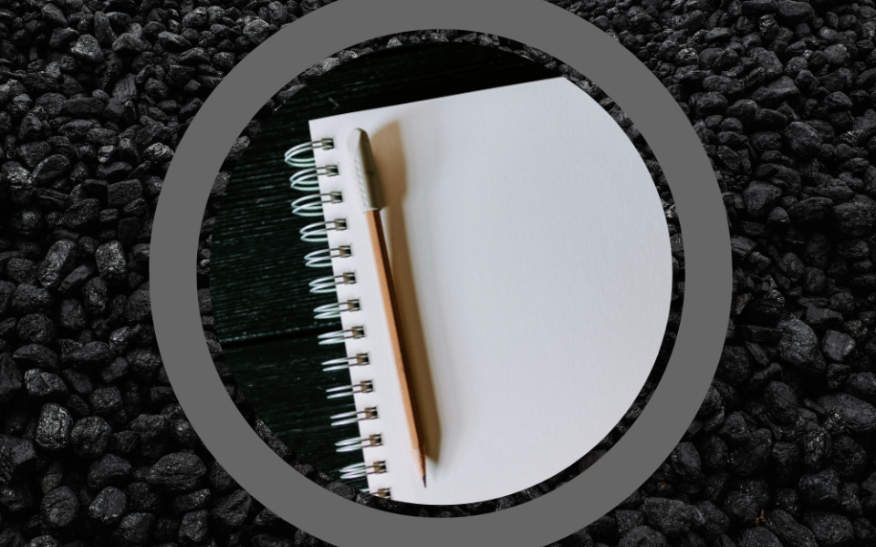 Photo of a notebook with a pencil on a background photo of coal (GSR graphic/Unsplash photos/Kelly Sikkema, Ottr Dan)