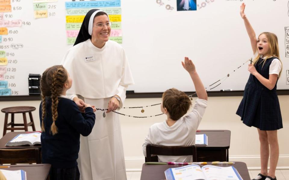 Sr. Amelia Hueller of the Dominican Sisters of St. Cecilia Congregation in Nashville, Tenn., visits a third-grade classroom at Providence Academy in Plymouth, Minn., Jan. 12, 2026, and explains her habit to the students, including Emily Jewison, Duke Conway and Grace Wheeler. (OSV News/Dave Hrbacek, The Catholic Spirit)