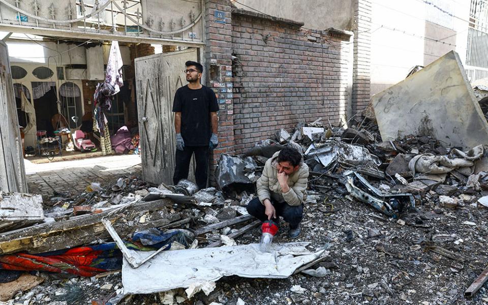 People react at the site of a residential building in Tehran, Iran, March 27, 2026, that was damaged by a strike amid the U.S.-Israeli war with Iran. (OSV News/West Asia News Agency via Reuters/Majid Asgaripour)