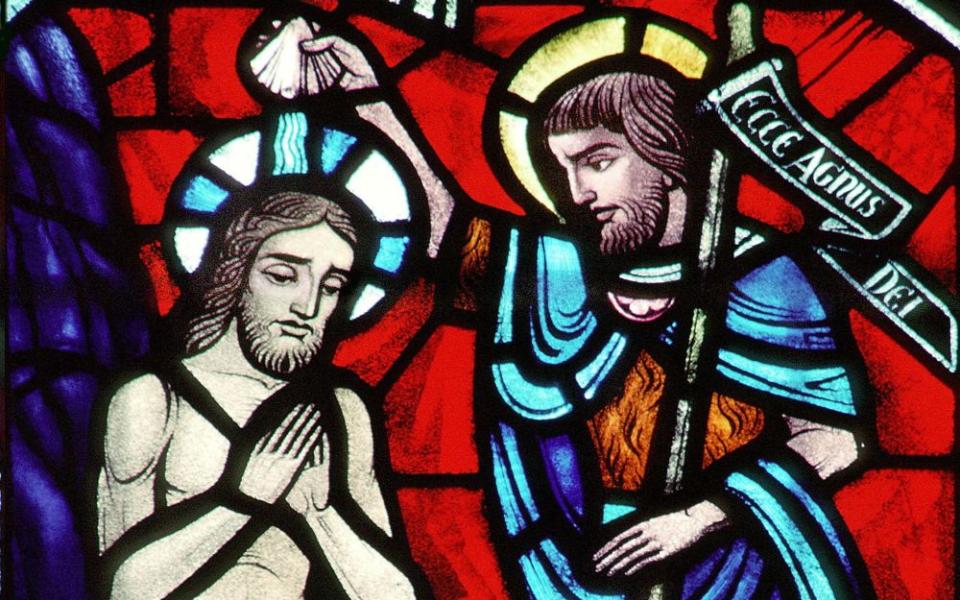 A church window depicts Christ's baptism by John the Baptist at the Jordan River. (CNS/Crosiers) 