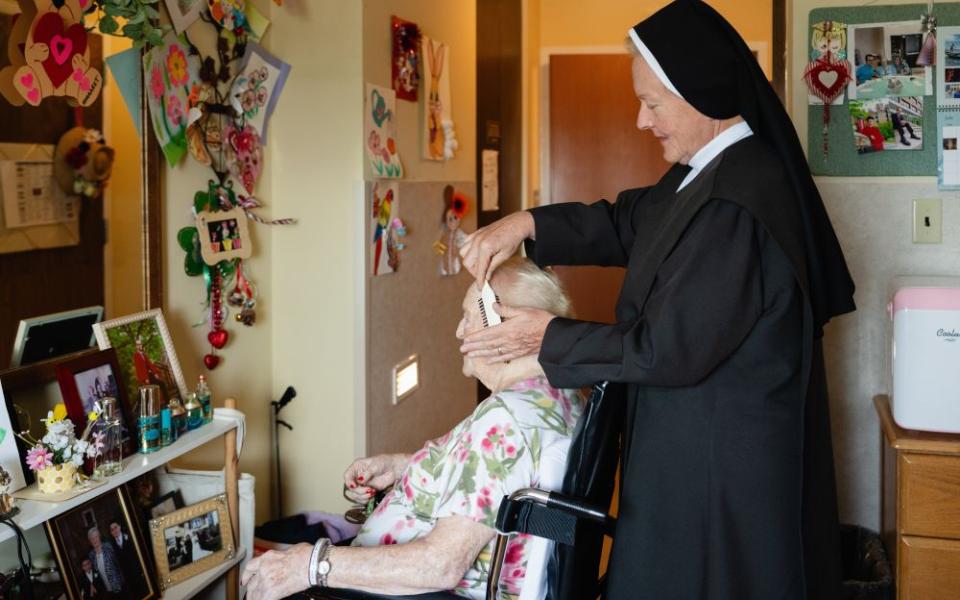 An undated photo shows a Carmelite sister combing a resident's hair at Ozanam Hall in Bayside, the New York borough of Queens. On July 30, 2026, a judge temporarily shielded four orders of women religious and Catholic healthcare ministries from enforcement of a New York state law allowing physicians to aid terminally ill adults in dying by suicide. (OSV News/Courtesy Becket)