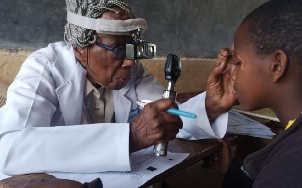 Dr. Sr. Marlene Long gives a patient an eye exam during the Primary School Eye Health Project in Ngong, Kenya in the early 2000s. (Courtesy of Marlene Long)