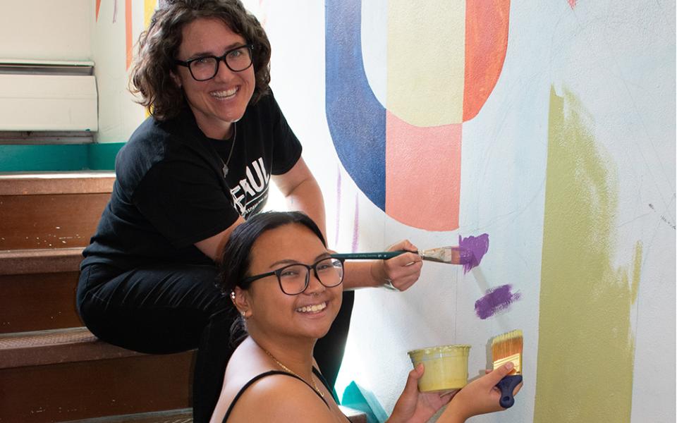St. Joseph Sr. Bethany Welch paints with one of the transitional housing residents. (Courtesy of Cathie Meighan)