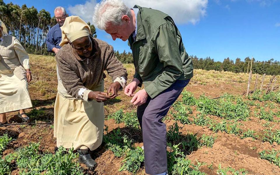 Sister Veronica, a member of the Little Sisters of St. Francis, shows a representative of the U.S. International Development Finance Corporation produce from the Divine Mercy Green Farm her order operates in Nakuru, Kenya. (CNS/Handout, Missio Invest, Pontifical Missionary Societies in the United States)